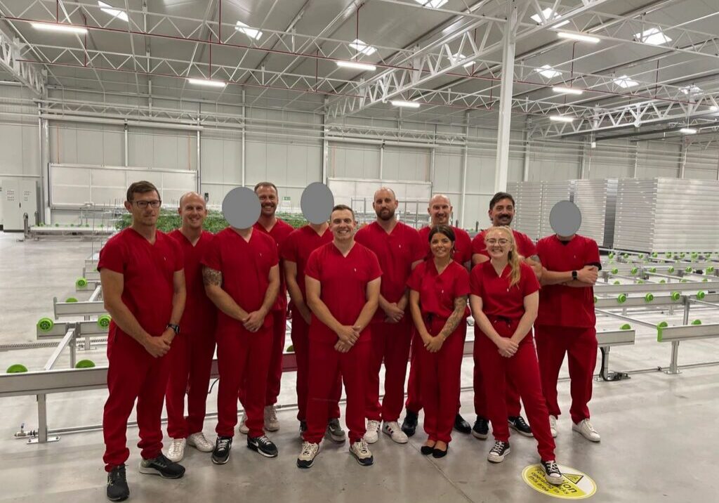 Workers posing in large industrial space