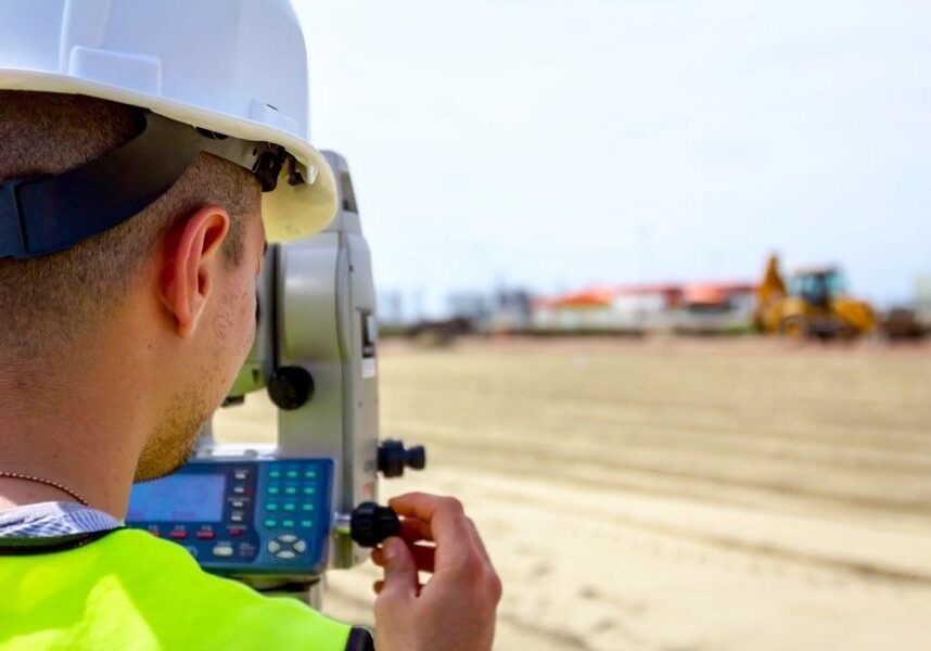 Man in hard hat surveying land