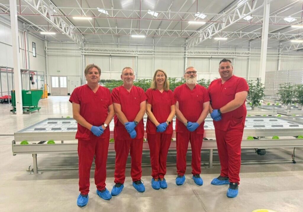 Team posing in agricultural facility